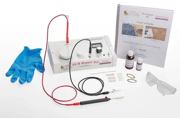 Workbench setup with tools for DIY PCB gold finger repair.