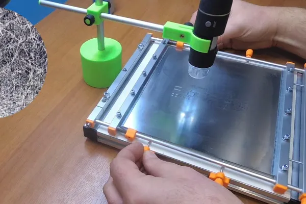 "Checking stencil alignment on PCB to prevent solder paste defects."