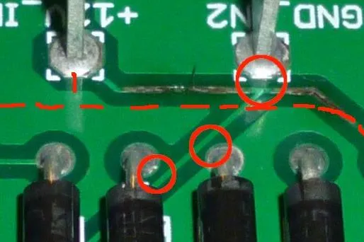 "Magnified view of solder mask pinholes on a PCB."