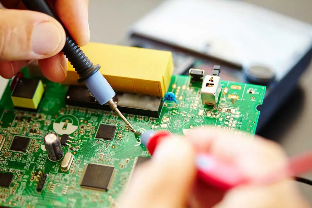 Applying adhesive to electronic components on a circuit board