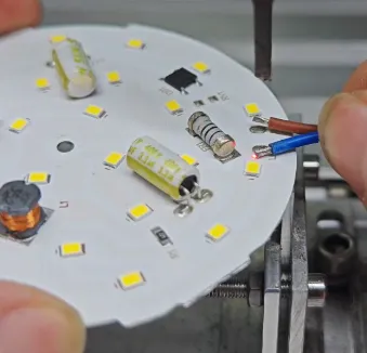 Soldering SMD LEDs onto a custom LED strip PCB.
