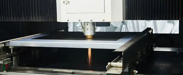 "Laser cutting machine creating precise apertures in an SMT stencil for high-precision assembly."