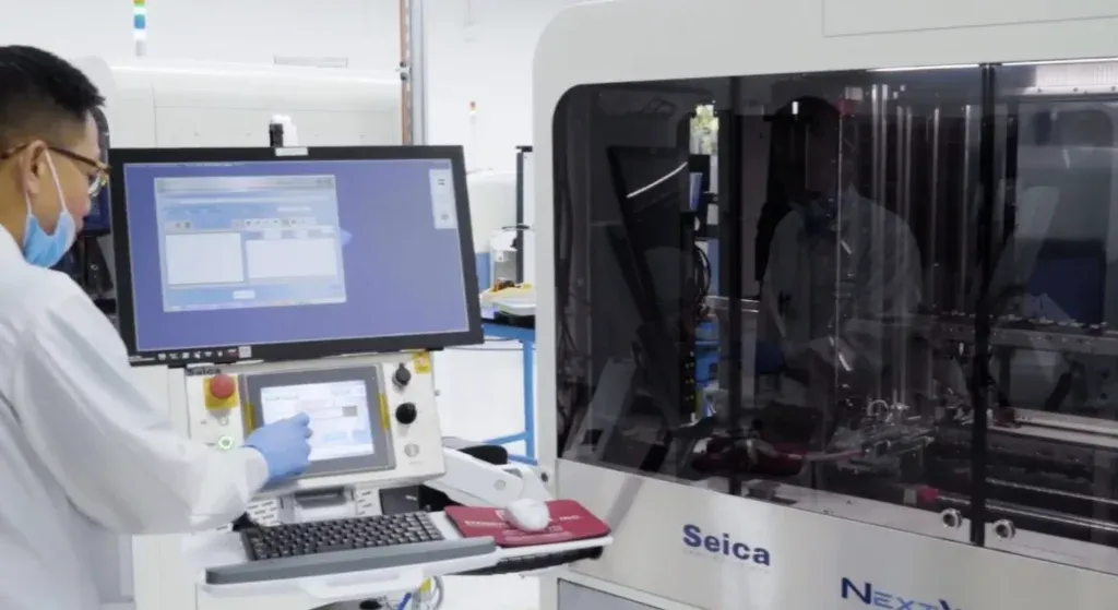 Technician calibrating flying probe tester for accurate PCB testing.