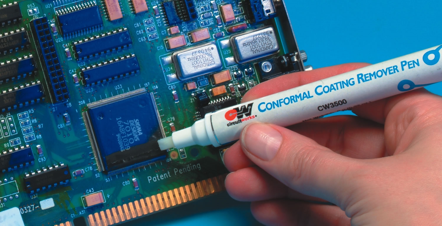 Technician applying solvent for conformal coating removal on a PCB.