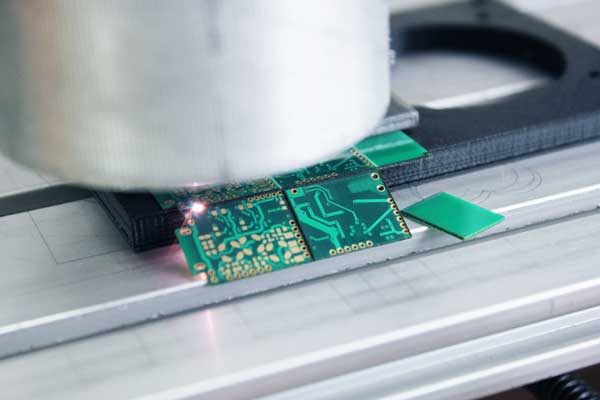 Laser PCB depaneling machine cutting a circuit board with precision