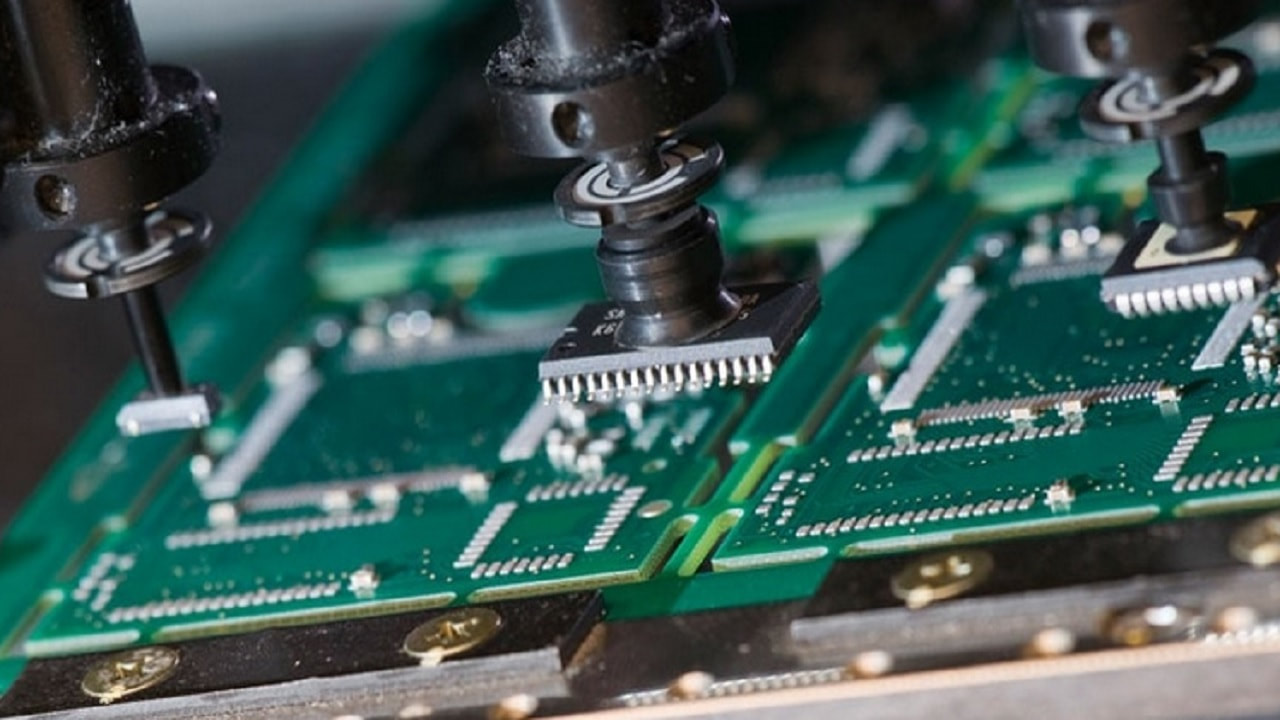 "SMT machine placing components during multi-layer PCB assembly."