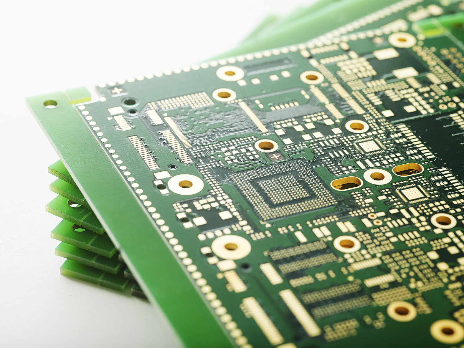 Close-up of PCB drill holes showing different sizes for vias and components