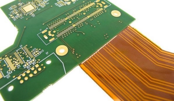 Magnified view of a failed rigid-flex PCB showing cracks and delamination."
