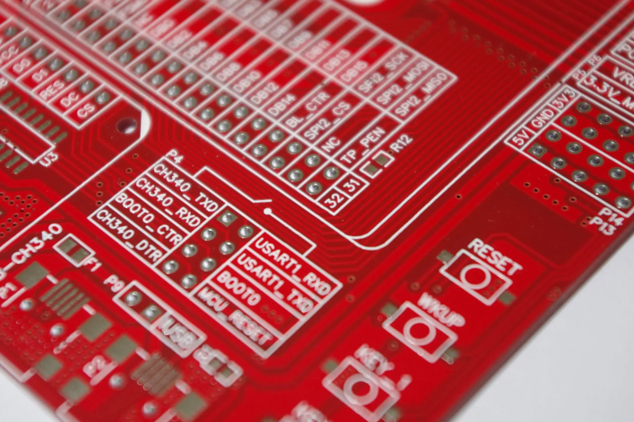 Red-PCB-with-microcontroller-and-connection-pins-scaled