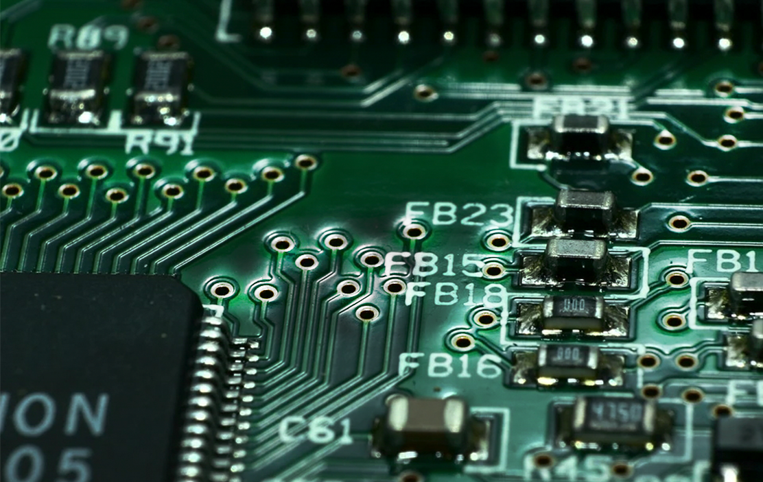PCB design layout highlighting green solder mask clearances and via tenting