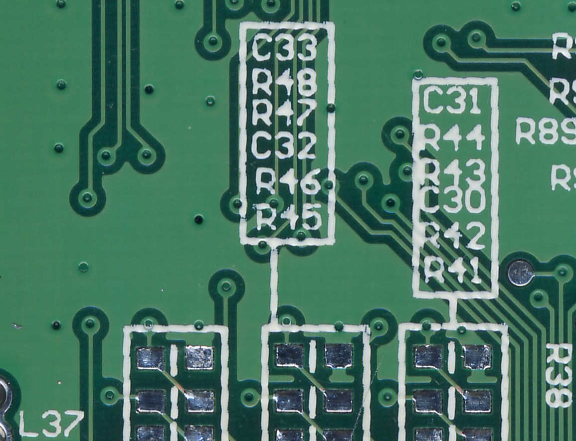 Blurred vs. clear silkscreen markings on a PCB."