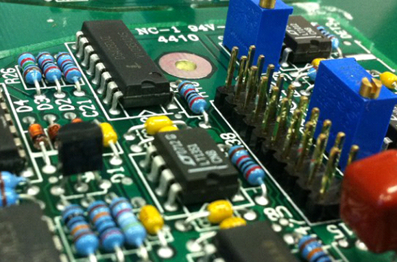 Close-up of through-hole components on a PCB for high-stress applications.