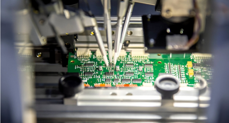 Prototype PCB undergoing flying probe testing in a lab