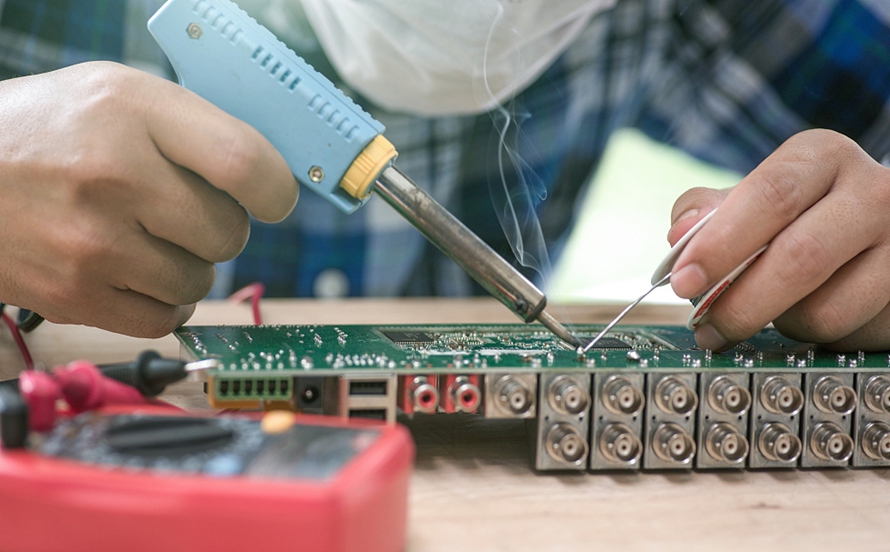 Manual soldering technique for through-hole PCB assembly"