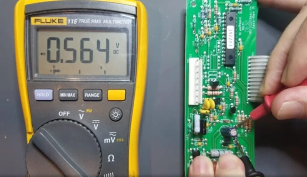 Testing a transistor on a PCB using a multimeter for troubleshooting