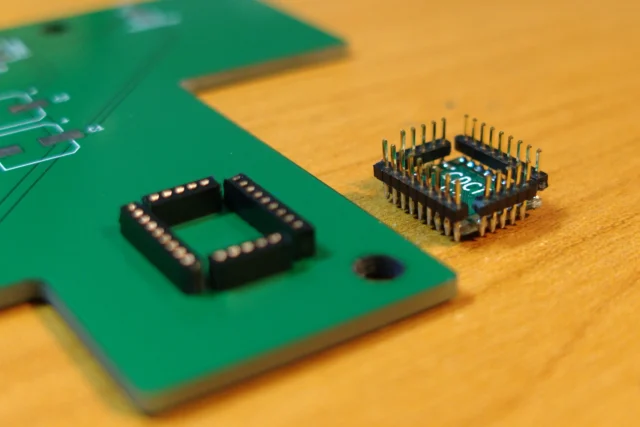 Finished PCB with components mounted in precisely drilled holes.