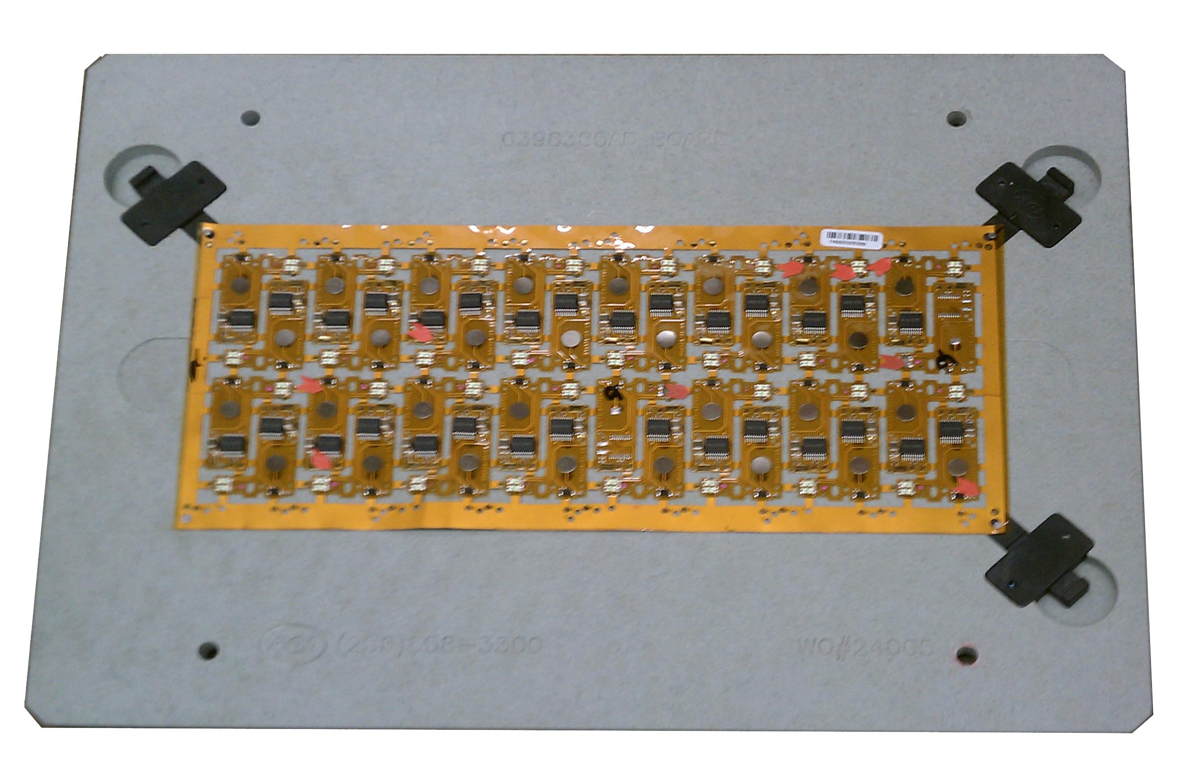 Flex PCB secured in a fixture to prevent component misalignment during assembly.