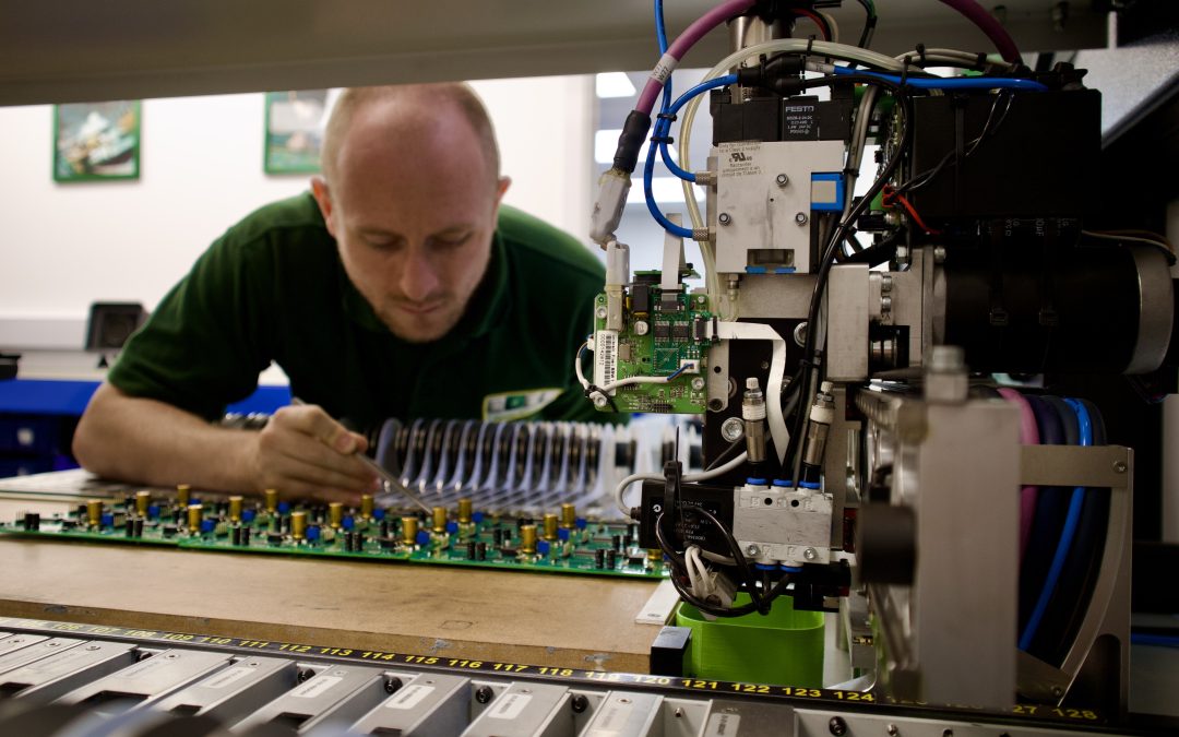 Technician performing pick and place machine calibration for SMT accuracy