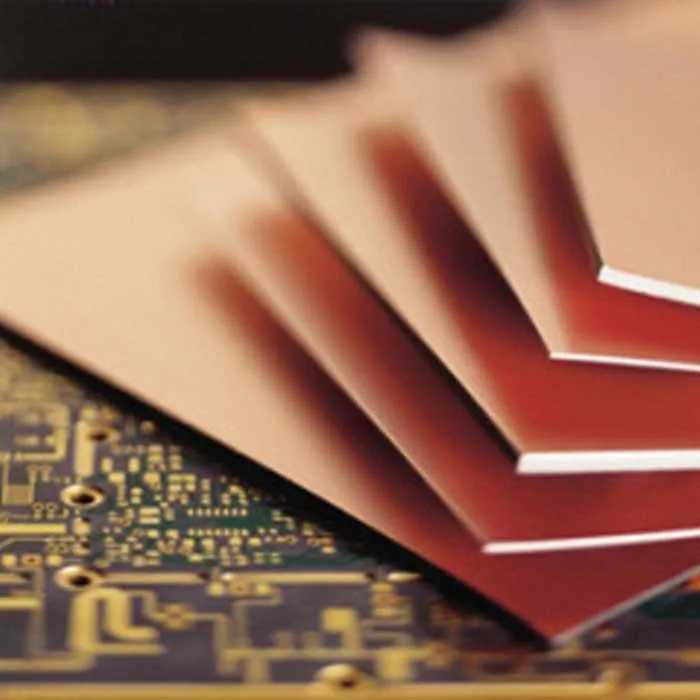 Close-up of FR-4 PCB with copper traces and mounted components for DIY assembly