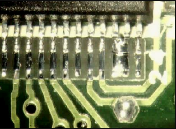 PCB with manufacturing errors like solder bridging