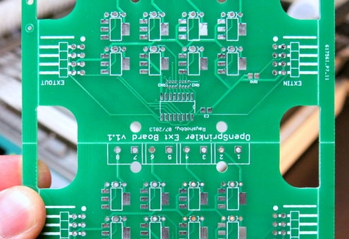 Close-up of V-cut groove on PCB panel for depaneling.