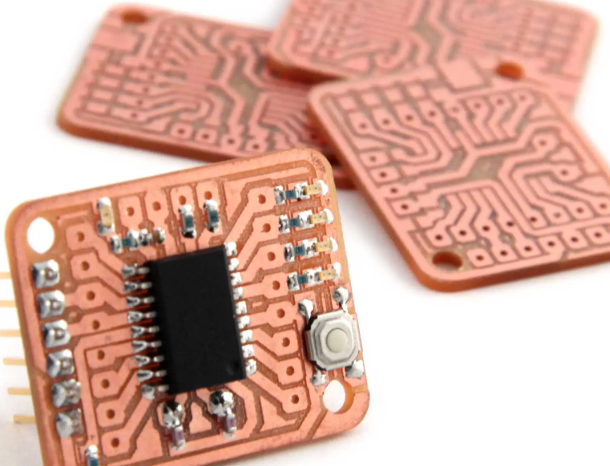 Old PCBs repurposed into custom breakout boards for rapid prototyping."