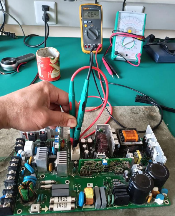 PCB repair workbench with soldering tools and equipment.