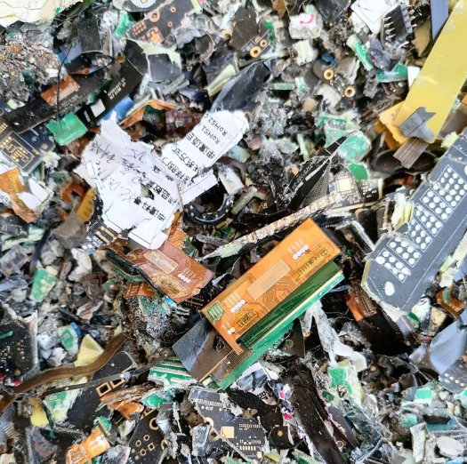 Discarded PCB in landfill highlighting environmental risks of improper disposal.