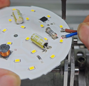 Soldering SMD LEDs onto a custom LED strip PCB.