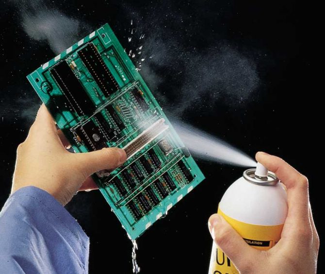PCB being washed with distilled water using a spray bottle