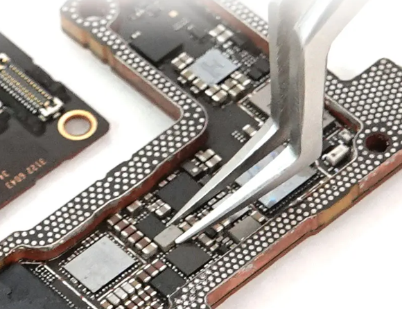 Precision tools like tweezers and pliers for PCB component placement."