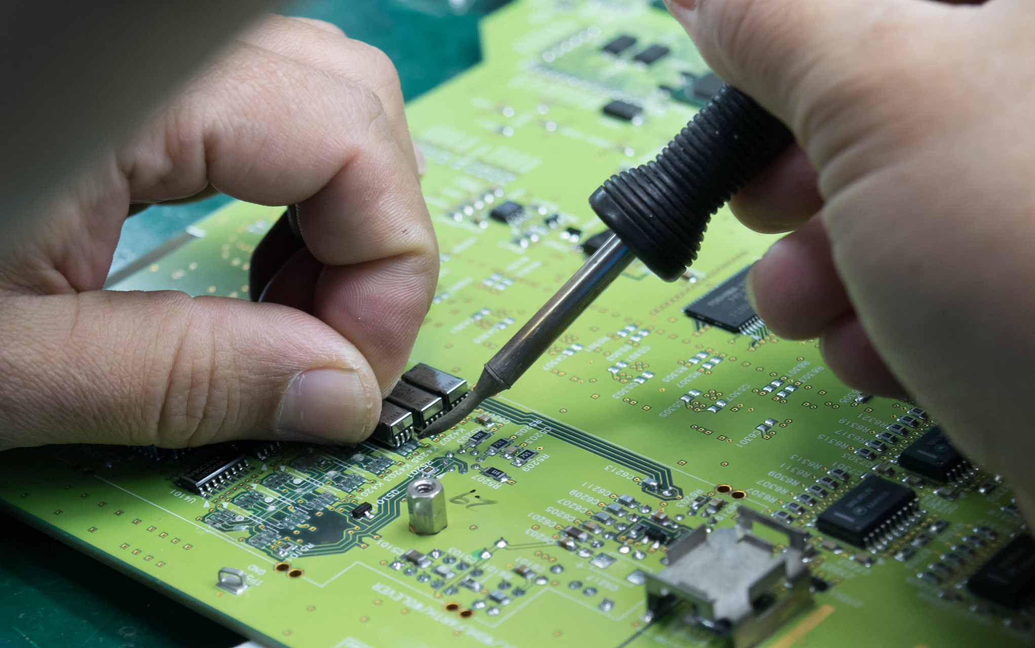 Student prototyping a circuit with hardware tools for PCB design