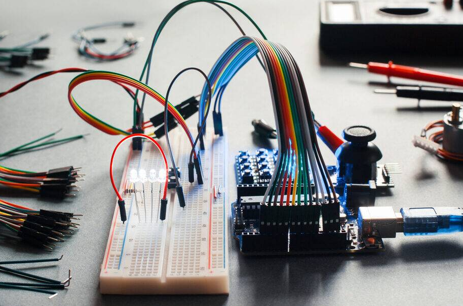 Breadboard PCB prototype assembly with components and jumper wires connected.