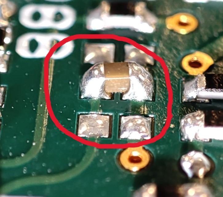 Close-up of a PCB with hand-soldered 0402 components