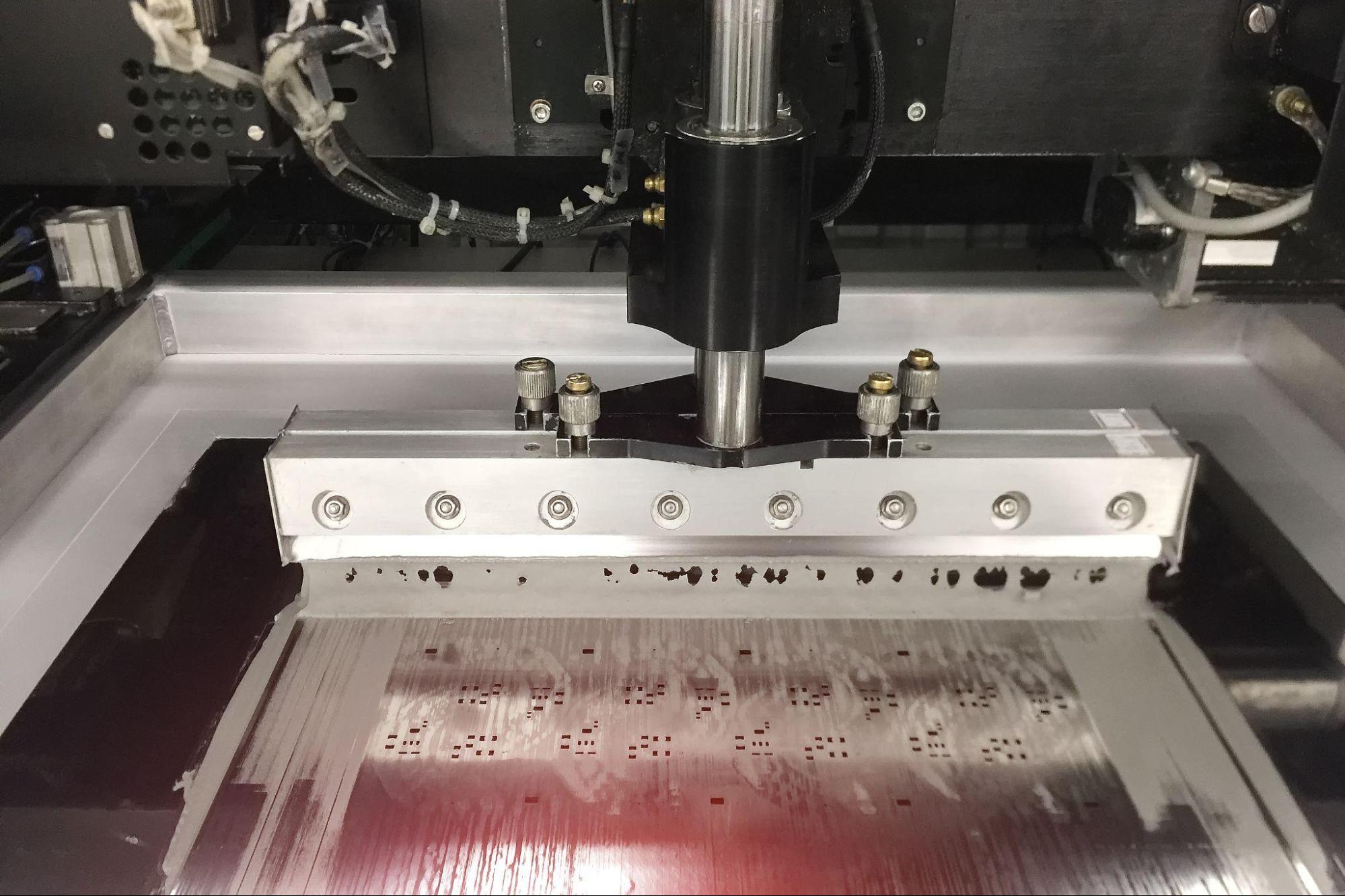 Applying solder paste using a stencil for PCB assembly.