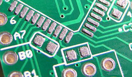 PCB with solder paste applied via DIY stencil printing.