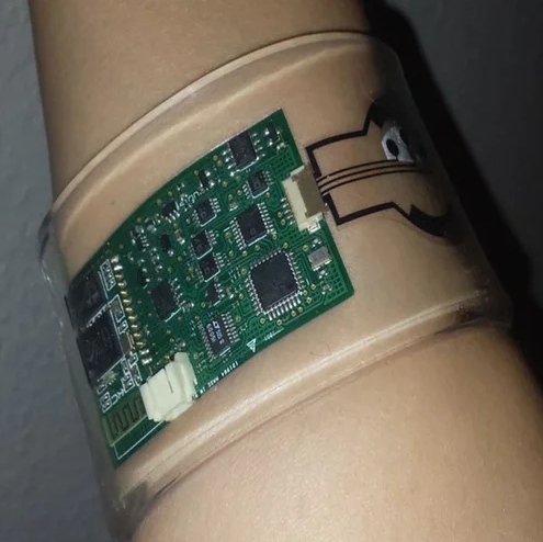 Irregular PCB shape in a compact wearable device for space optimization.