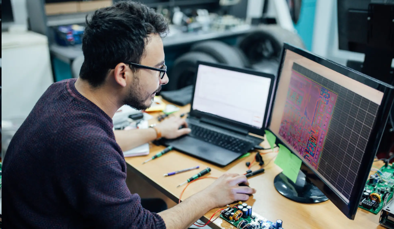 Developer programming drone flight controller PCB using firmware configurator software.