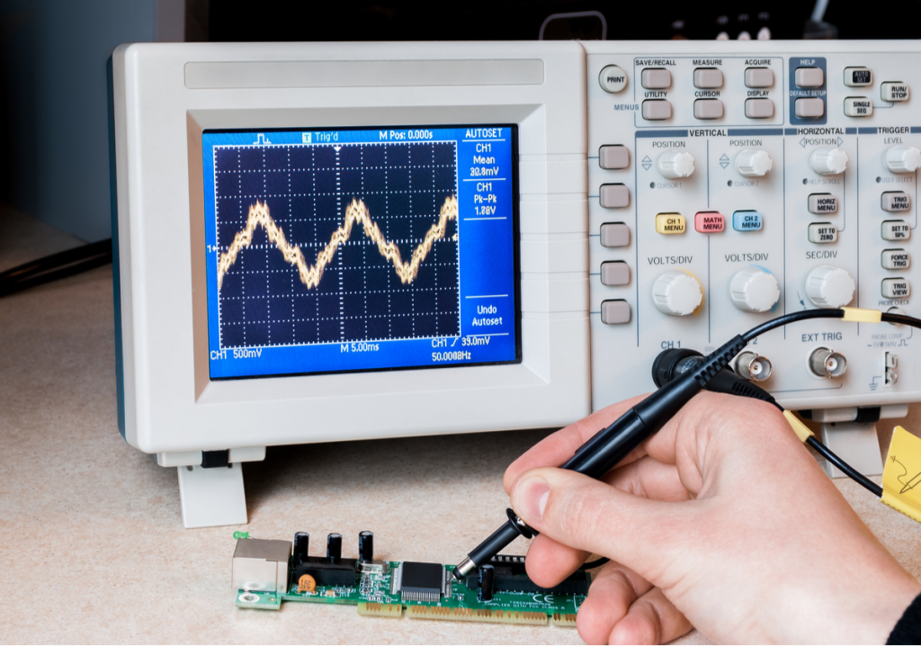 Technician troubleshooting a pacemaker PCB with an oscilloscope to check signal integrity