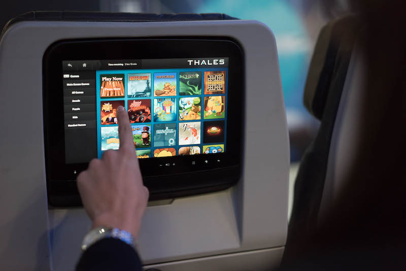 Passengers using advanced in-flight entertainment systems in an aircraft cabin