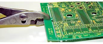 Manual breakaway tab removal of a PCB from a panel.