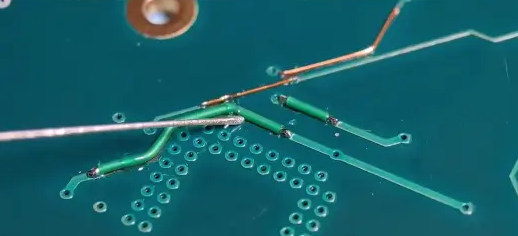 Soldering a small break in a PCB trace.