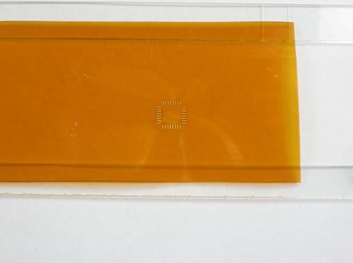 Preparing Kapton film for cutting an SMD PCB stencil using a laser cutter.