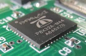Close-up of QFN component with bottom-terminated connections on PCB
