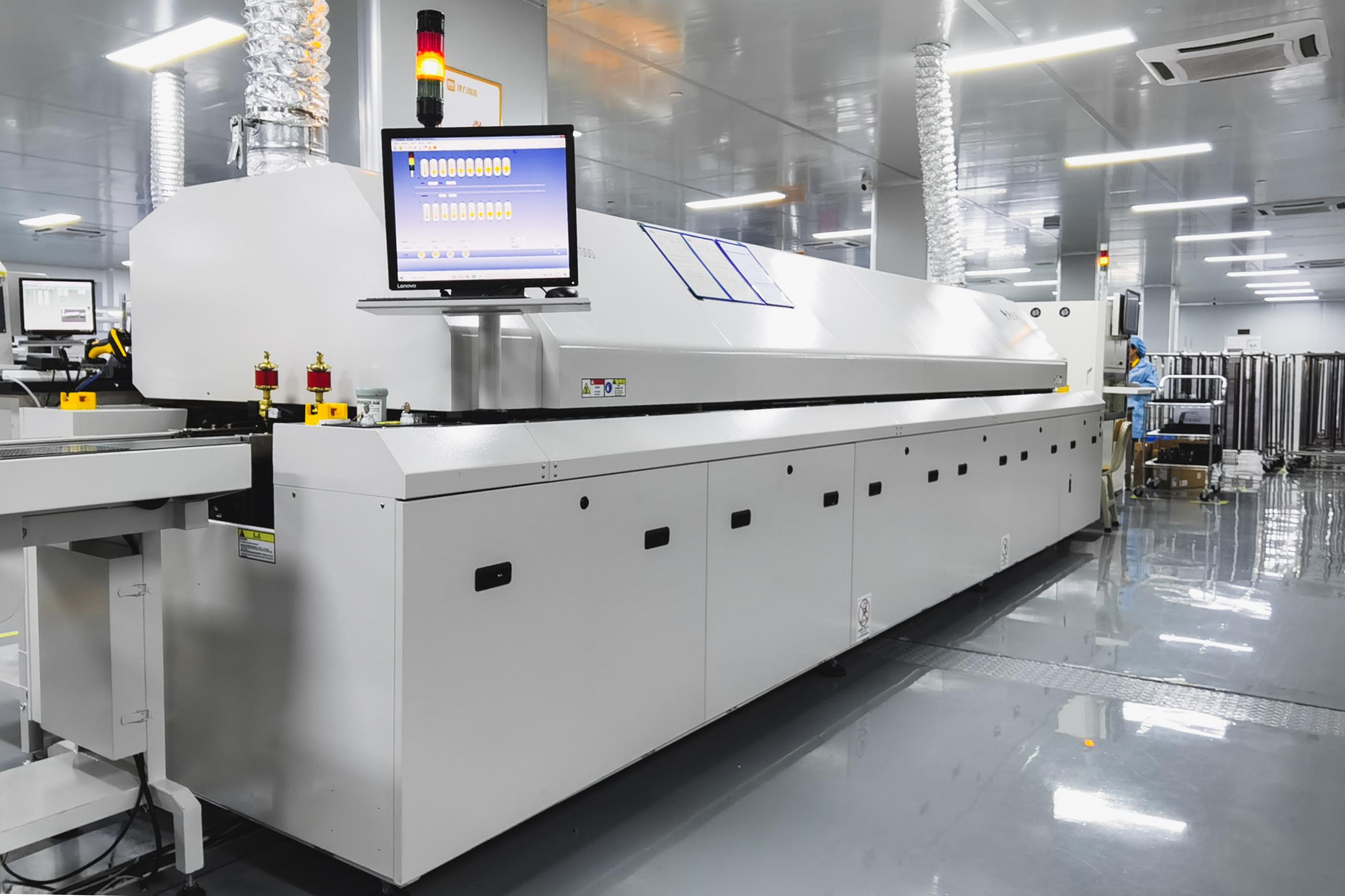 Wave soldering machine in action for through-hole components on an ADAS PCB