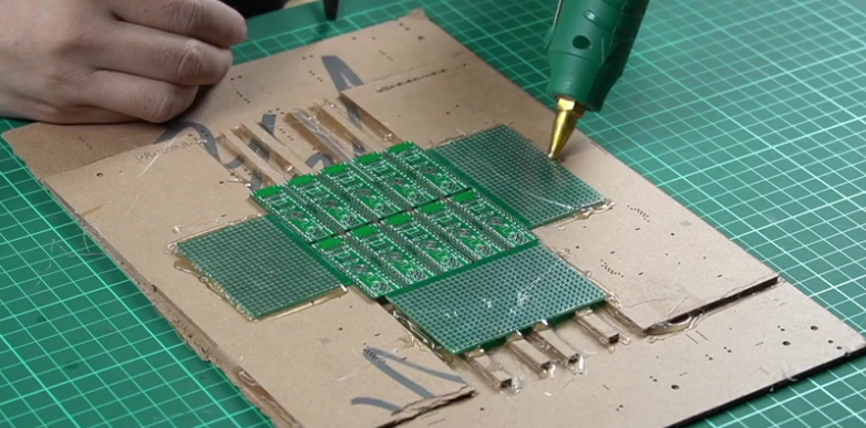 Unmounted stencil aligned on PCB for micro SMD solder paste application.