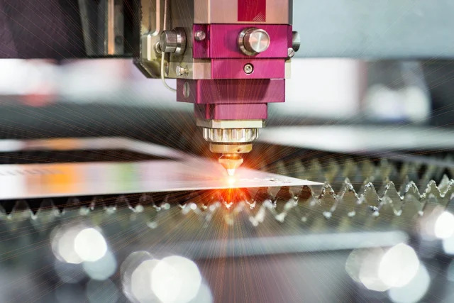 Laser drilling machine creating precise holes in a circuit board for smart home sensor