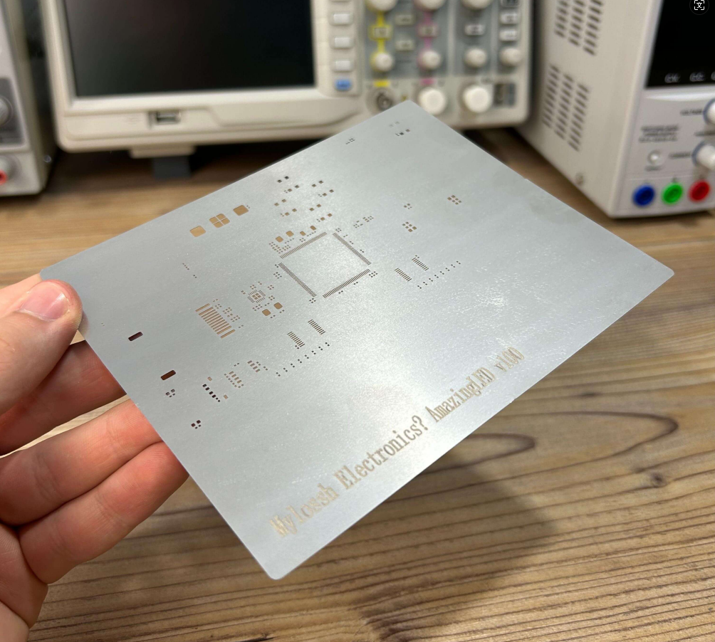 Technician inspecting PCB stencil quality at a local manufacturing facility.