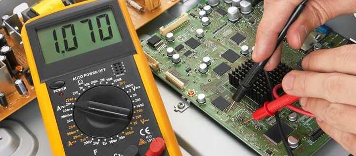 Hobbyist testing continuity on a blind via PCB with a multimeter.
