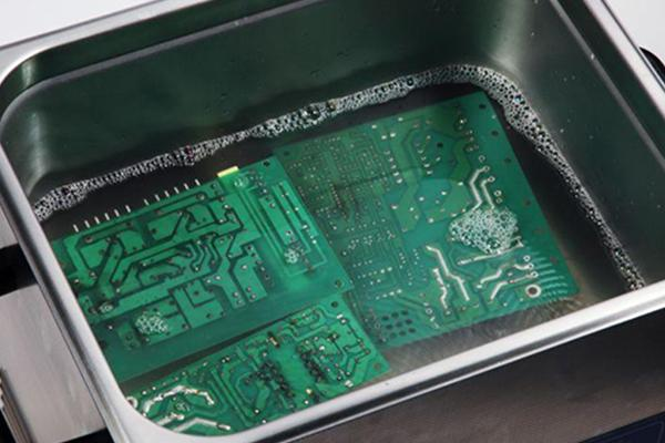 Ultrasonic cleaning of a mixed technology PCB.